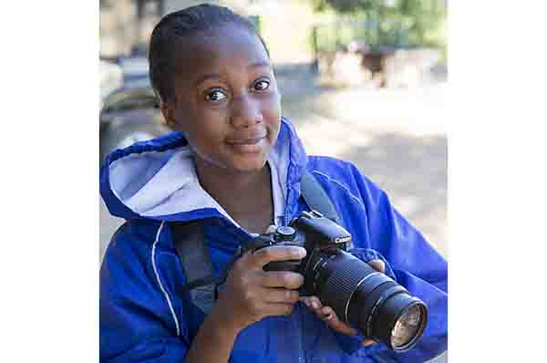 Pupil Evelyn Lekanyane with DSLR camera during residential photography course organised by Wild Shots Outreach. Kruger National Park, South Africa, June 2017.